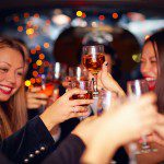 beautiful women drinking in a limo