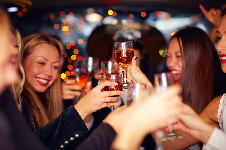 beautiful women drinking in a limo